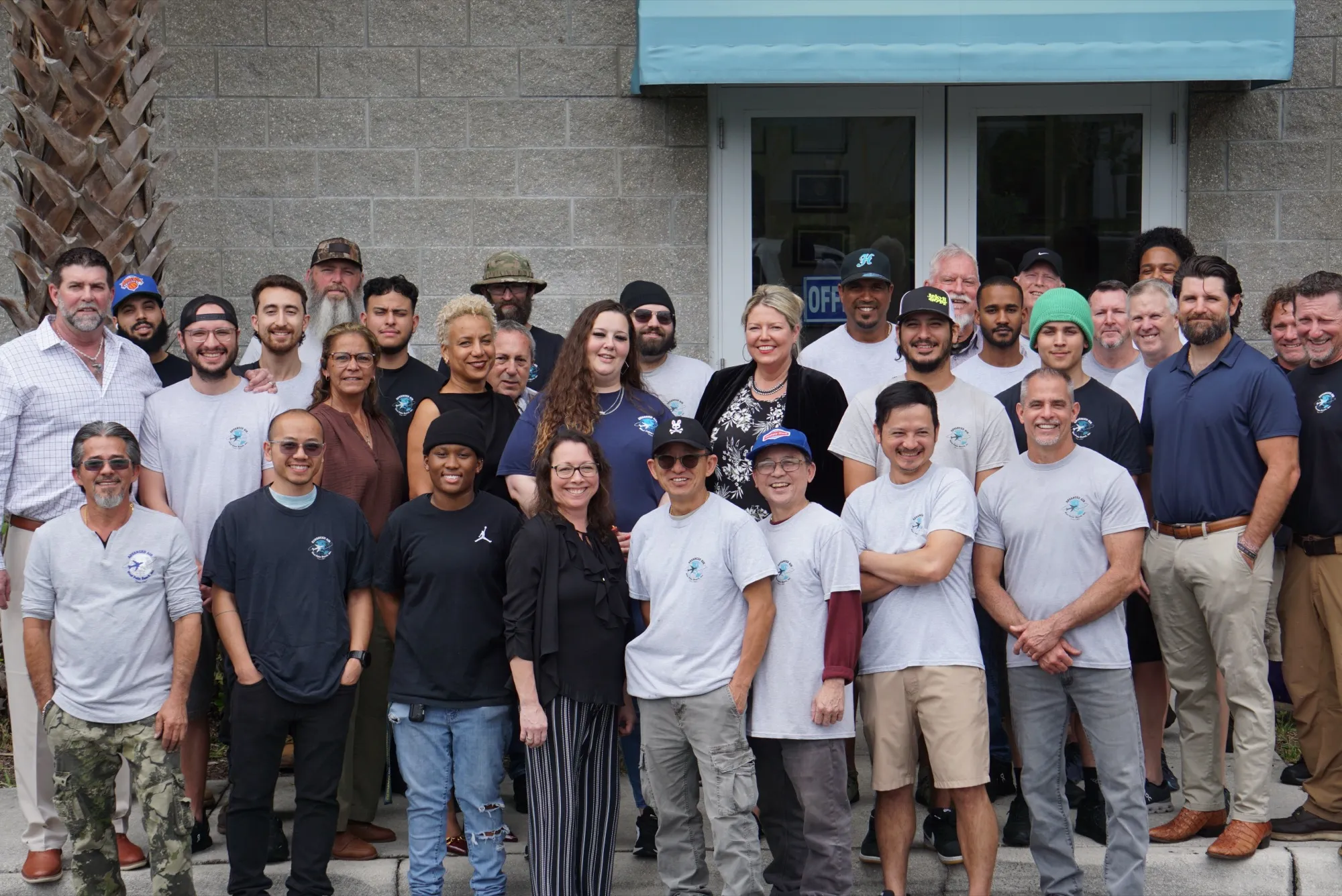 Advanced Air team gathered at the 14540 Sand Holly Cir. facility entrance in Jupiter, Florida